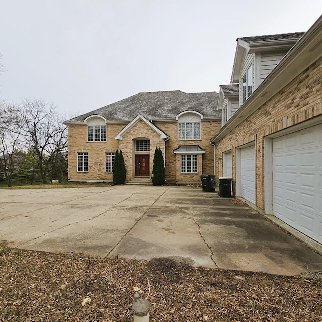 view of front of home featuring central AC unit and a garage