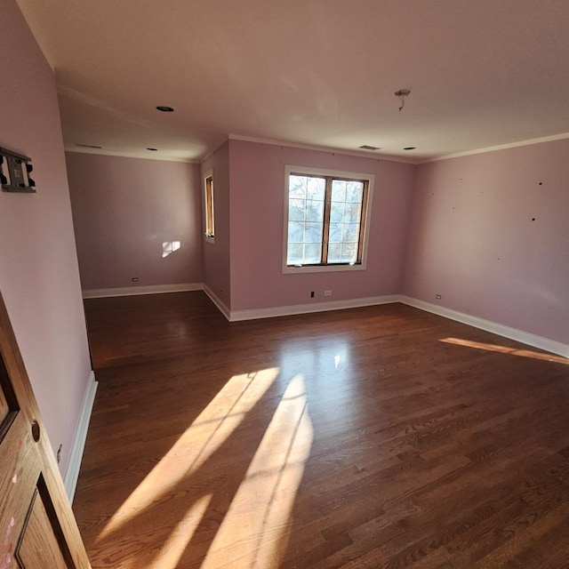 unfurnished room with crown molding and dark wood-type flooring