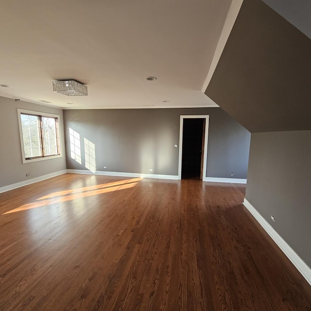 interior space with wood-type flooring and vaulted ceiling