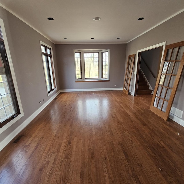 empty room featuring dark hardwood / wood-style floors and ornamental molding