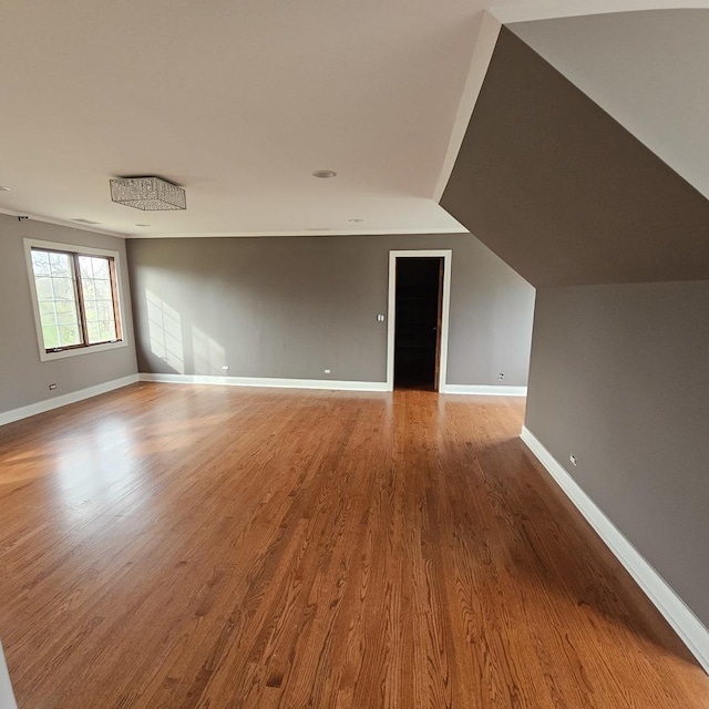 interior space featuring hardwood / wood-style flooring and vaulted ceiling