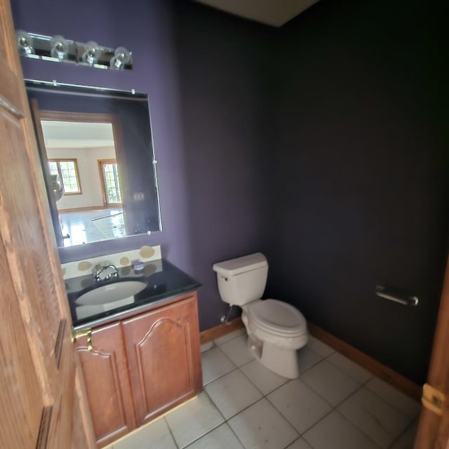 bathroom featuring tile patterned floors, vanity, and toilet