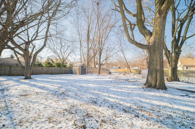 snowy yard with a shed