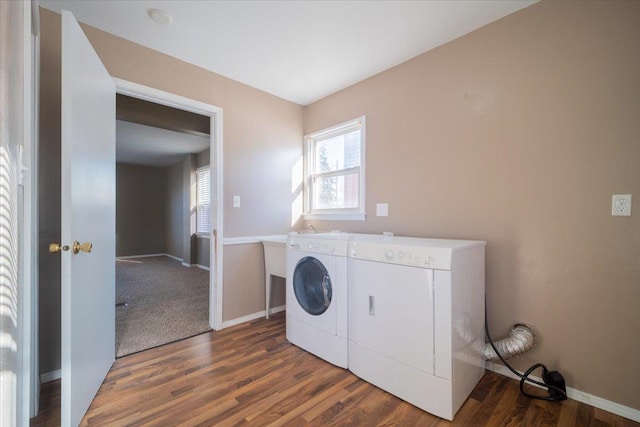 clothes washing area with dark hardwood / wood-style flooring and washing machine and dryer