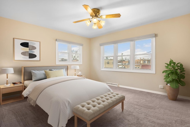 bedroom with ceiling fan, carpet, and a baseboard heating unit