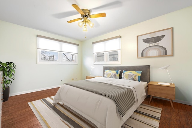 bedroom with ceiling fan and dark hardwood / wood-style flooring