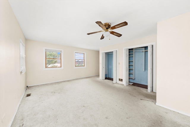 unfurnished bedroom with ceiling fan and light carpet