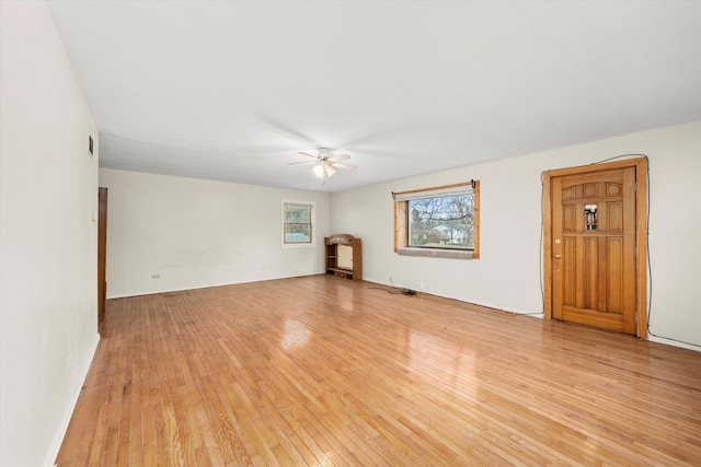 empty room featuring light wood-type flooring and ceiling fan