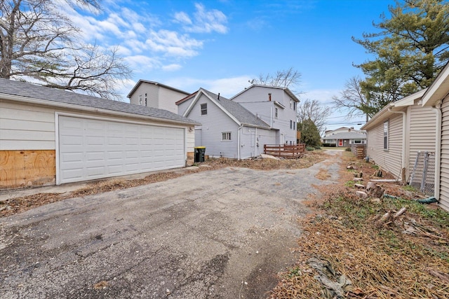 view of property exterior with a garage and an outbuilding