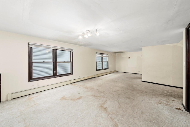 carpeted empty room with baseboard heating