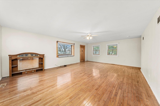 unfurnished living room with ceiling fan and light hardwood / wood-style flooring