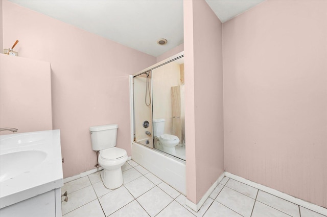 full bathroom with shower / bath combination with glass door, tile patterned floors, vanity, and toilet