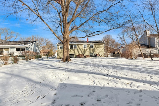 view of snow covered rear of property