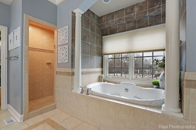 bathroom with tile patterned floors, separate shower and tub, and ornate columns