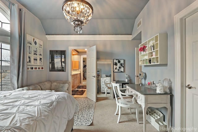 carpeted bedroom featuring ensuite bathroom and a chandelier