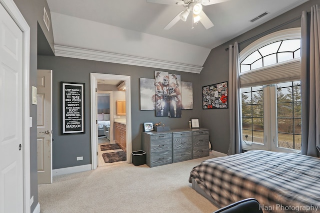 carpeted bedroom with vaulted ceiling, ceiling fan, crown molding, and ensuite bath