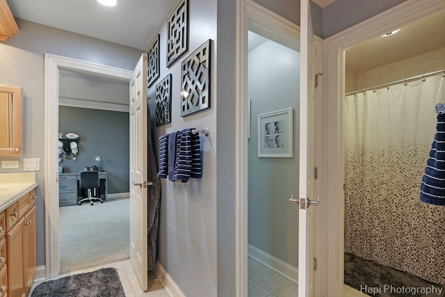 bathroom with a shower with curtain, tile patterned floors, and vanity