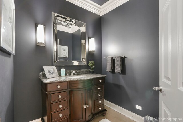 bathroom with ornamental molding and vanity