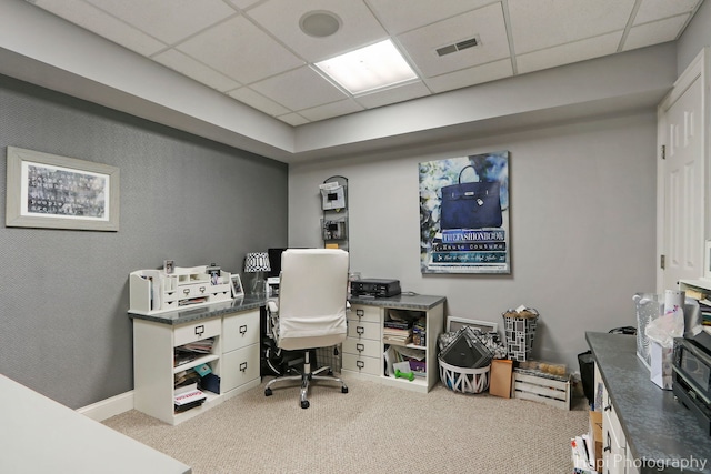 carpeted home office featuring a drop ceiling