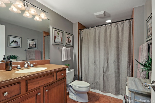 bathroom with tile patterned flooring, vanity, and toilet