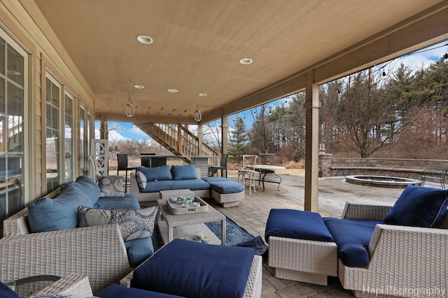 view of patio / terrace with an outdoor living space and a jacuzzi