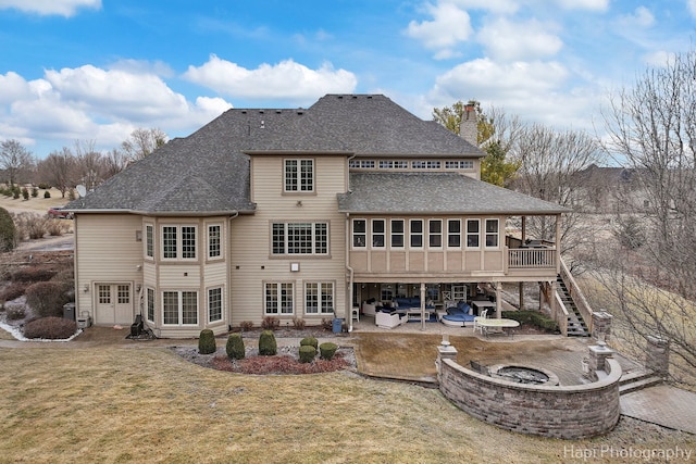 rear view of house with a patio, a yard, and an outdoor fire pit