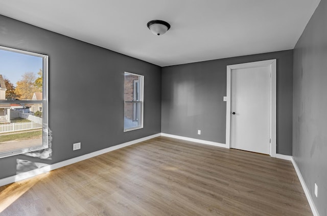 unfurnished room with hardwood / wood-style floors