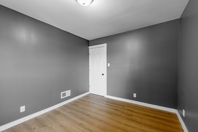 spare room with hardwood / wood-style flooring