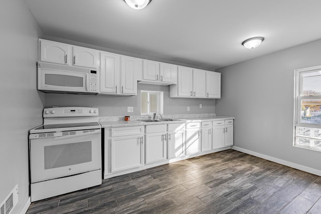 kitchen with white cabinetry, sink, and white appliances