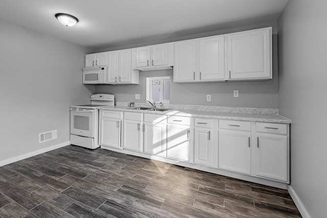 kitchen featuring sink, white appliances, and white cabinets