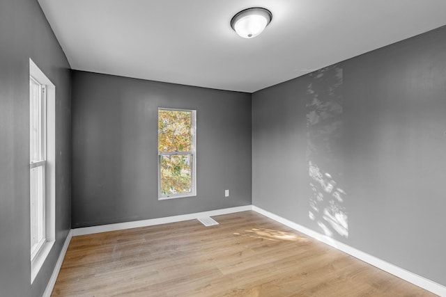 empty room with light hardwood / wood-style flooring