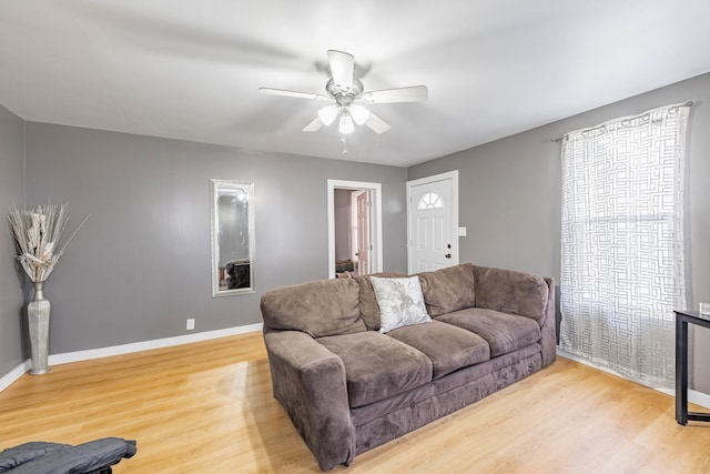 living room featuring light hardwood / wood-style floors and ceiling fan