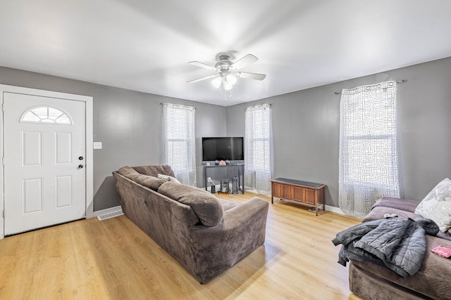 living room featuring light hardwood / wood-style floors and ceiling fan