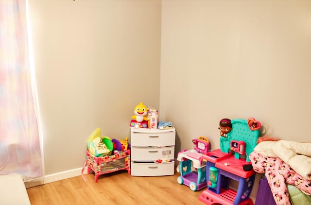 recreation room with hardwood / wood-style floors