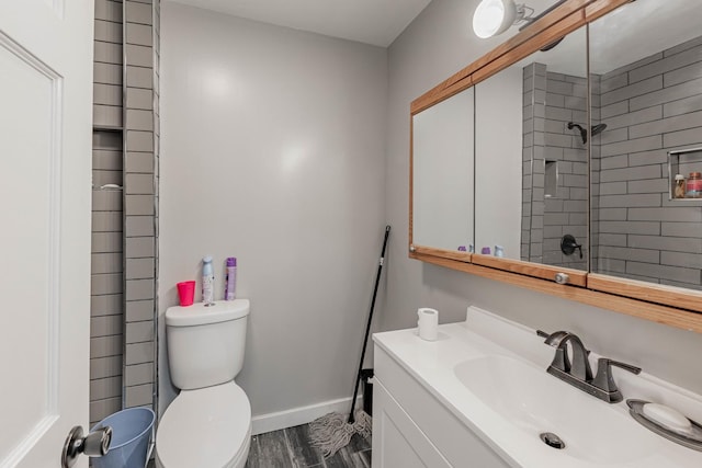 bathroom with hardwood / wood-style floors, toilet, and vanity