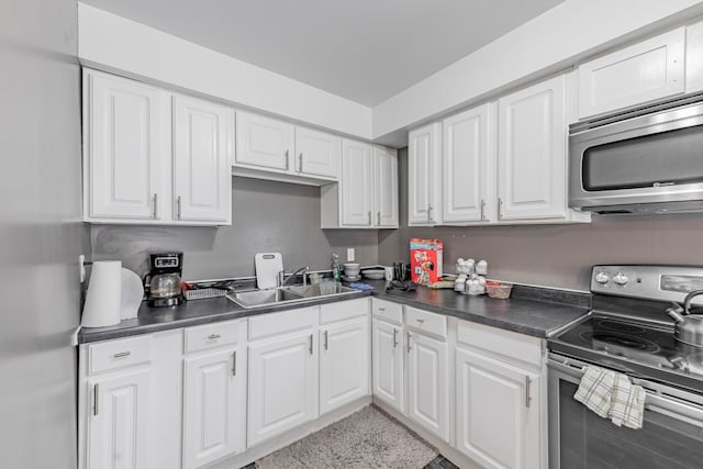 kitchen featuring white cabinets, appliances with stainless steel finishes, and sink