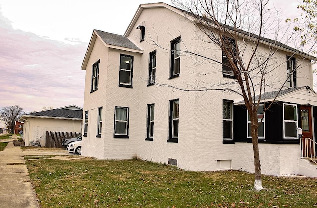 view of home's exterior with a lawn