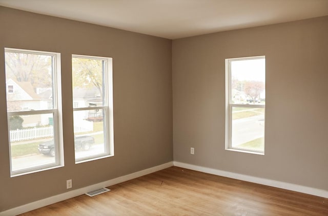 spare room with light hardwood / wood-style floors