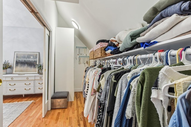 spacious closet with lofted ceiling and light wood-type flooring