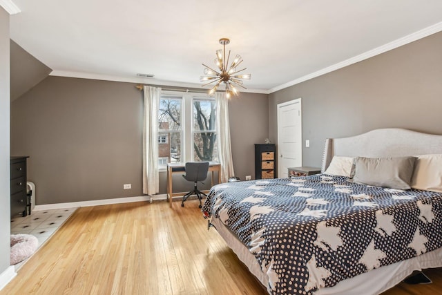 bedroom with an inviting chandelier, ornamental molding, and light hardwood / wood-style flooring