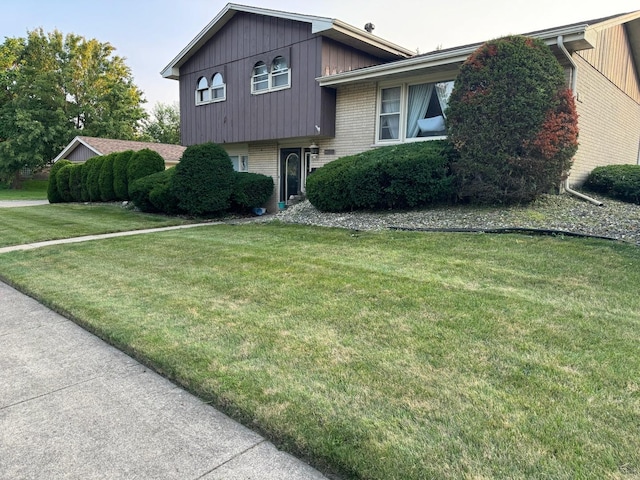 split level home featuring a front lawn