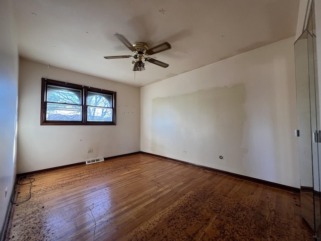 unfurnished room with hardwood / wood-style flooring and ceiling fan