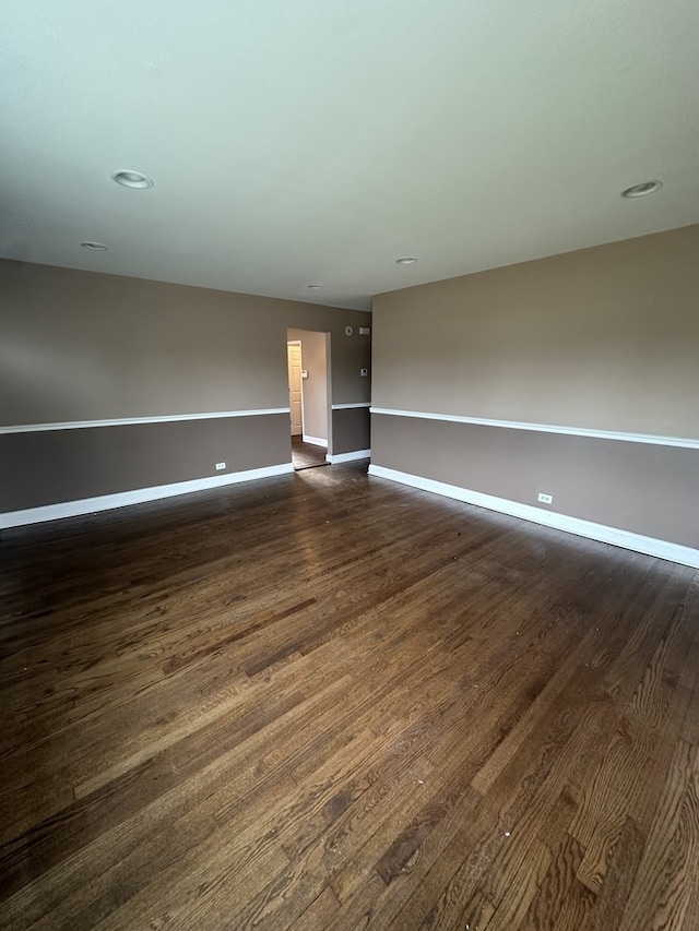 unfurnished room featuring dark wood-type flooring