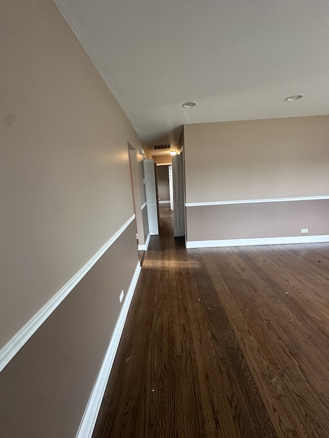 hallway with dark hardwood / wood-style flooring