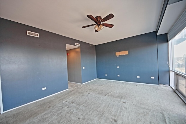 empty room with ceiling fan and light carpet