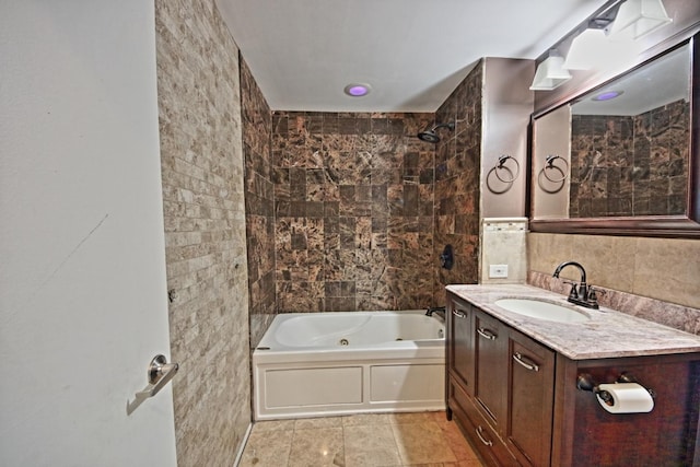 bathroom featuring vanity, tile walls, and tiled shower / bath