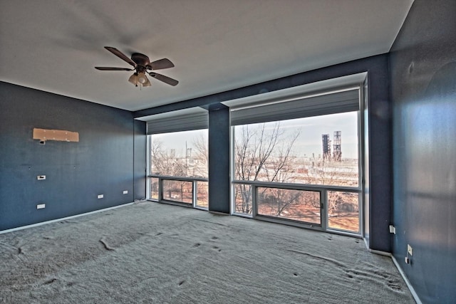 empty room featuring carpet floors and ceiling fan