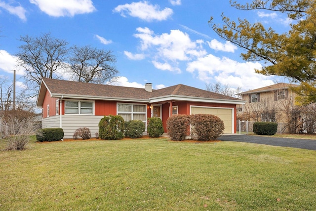 view of front of property featuring a front lawn and a garage