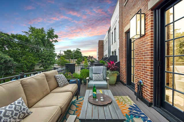 deck at dusk with outdoor lounge area