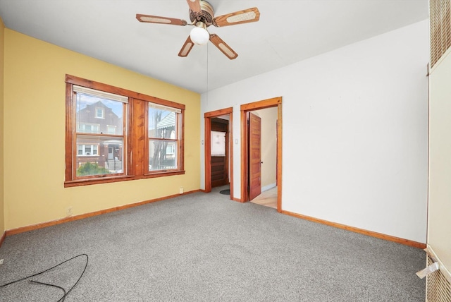 carpeted empty room featuring ceiling fan